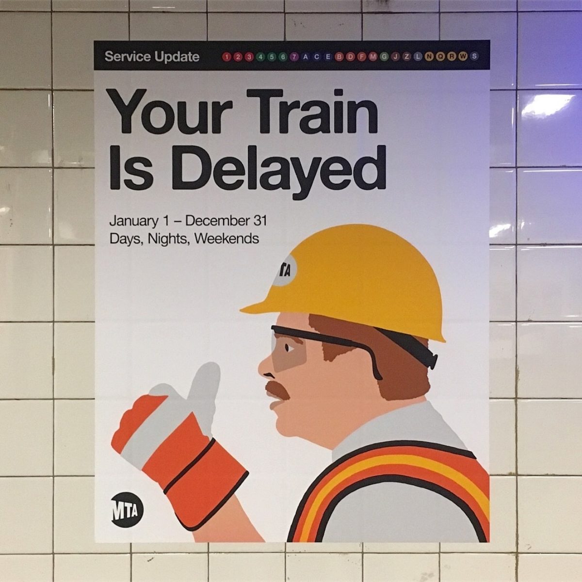 A tile wall with a white poster of a man wearing a safety vest, helmet, and gloves.