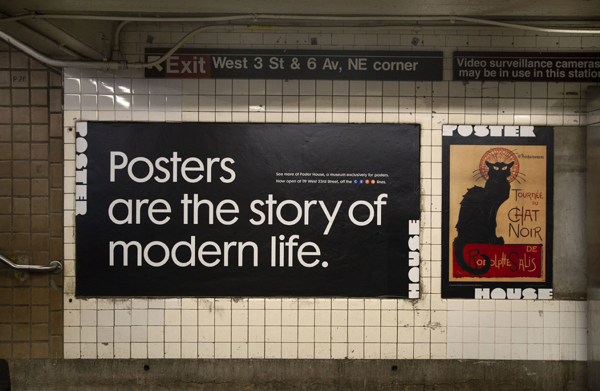 A train station advertisement of Poster House with a black cat poster near a station exit.