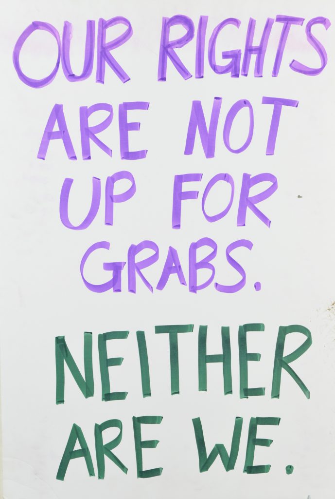 A poster of purple and green hand written text of 
