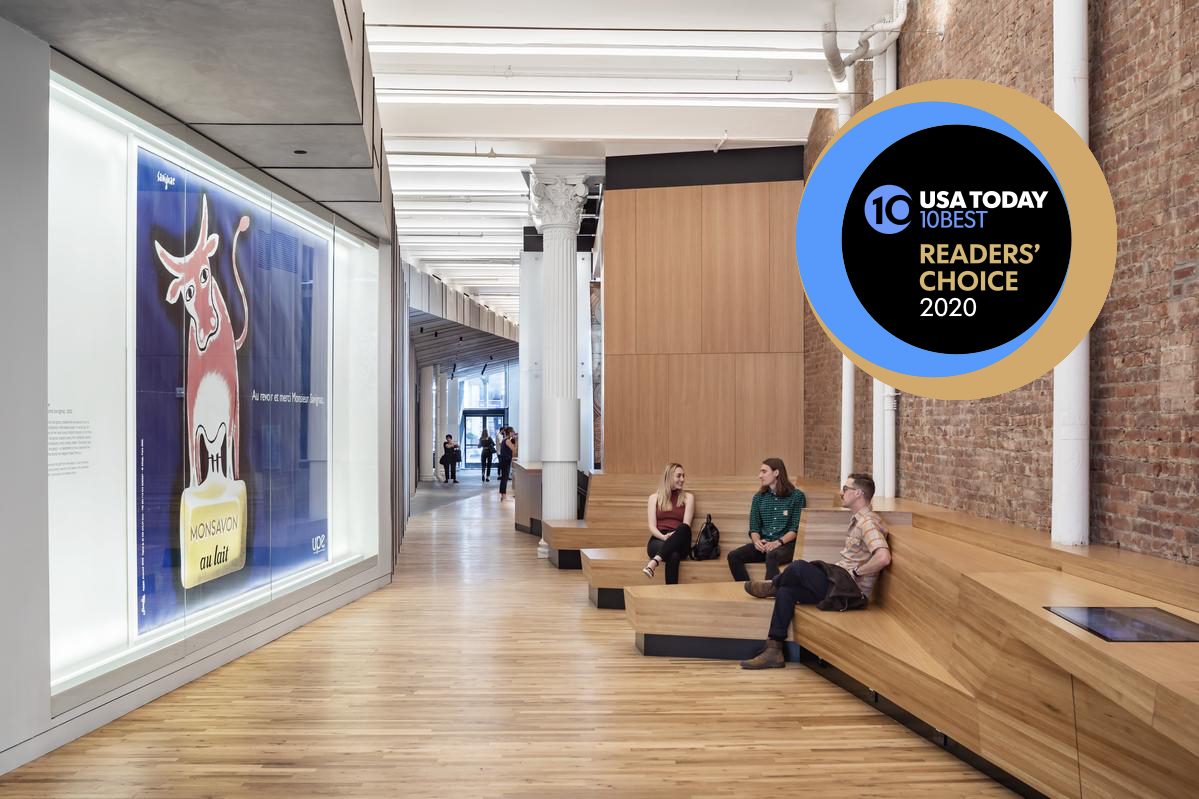 photograph of guests sitting in front of a billboard inside of Poster House