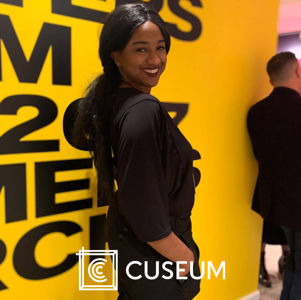 A cuseum promotion featuring a photograph of Education Programs Manager Sierra smiling.