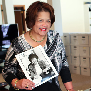 Author Cheryl D Miller holding a photograph.