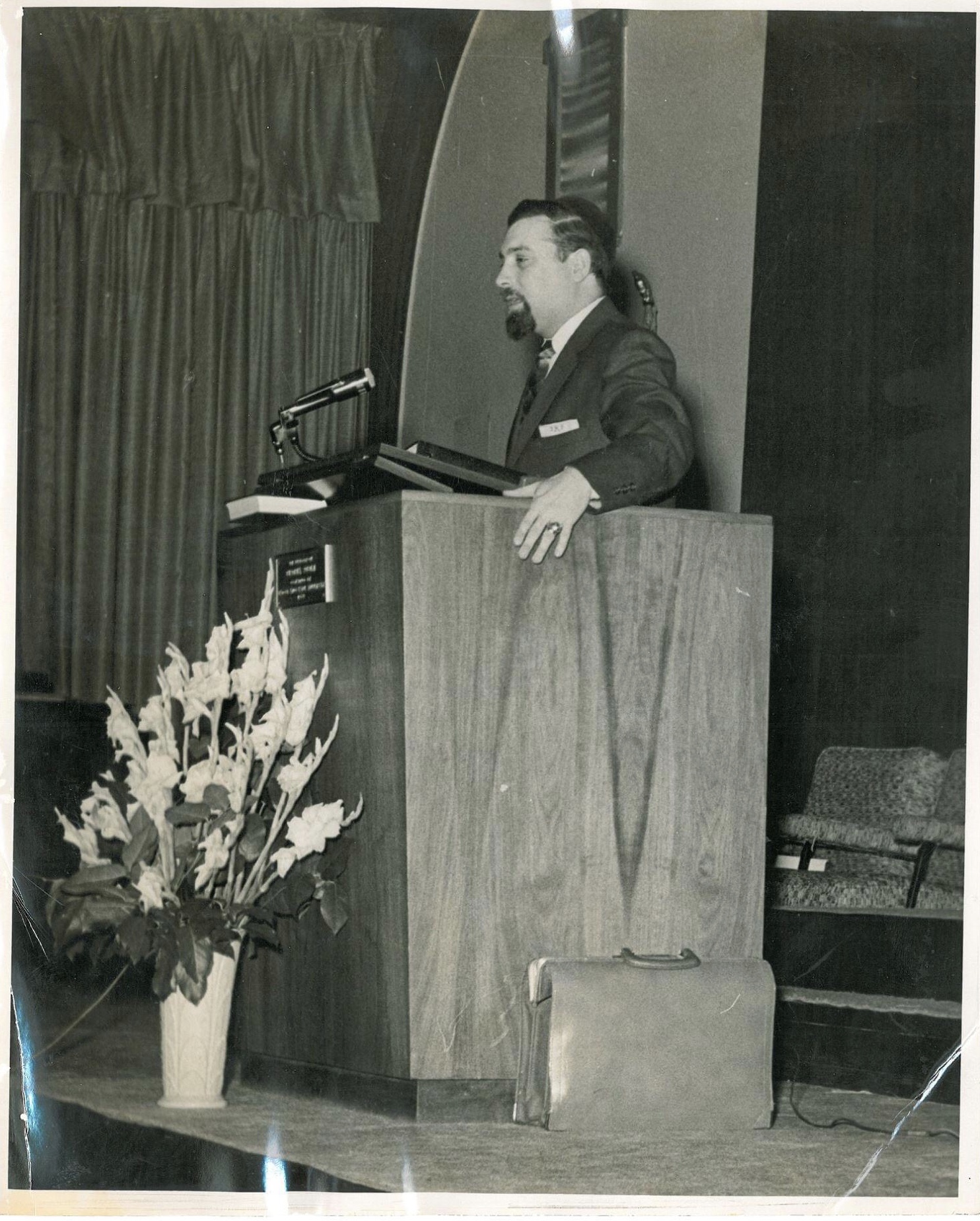 black and white photograph of a man at a pulpit