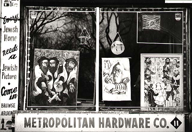 photograph of a gallery storefront window featuring jewish-themed art