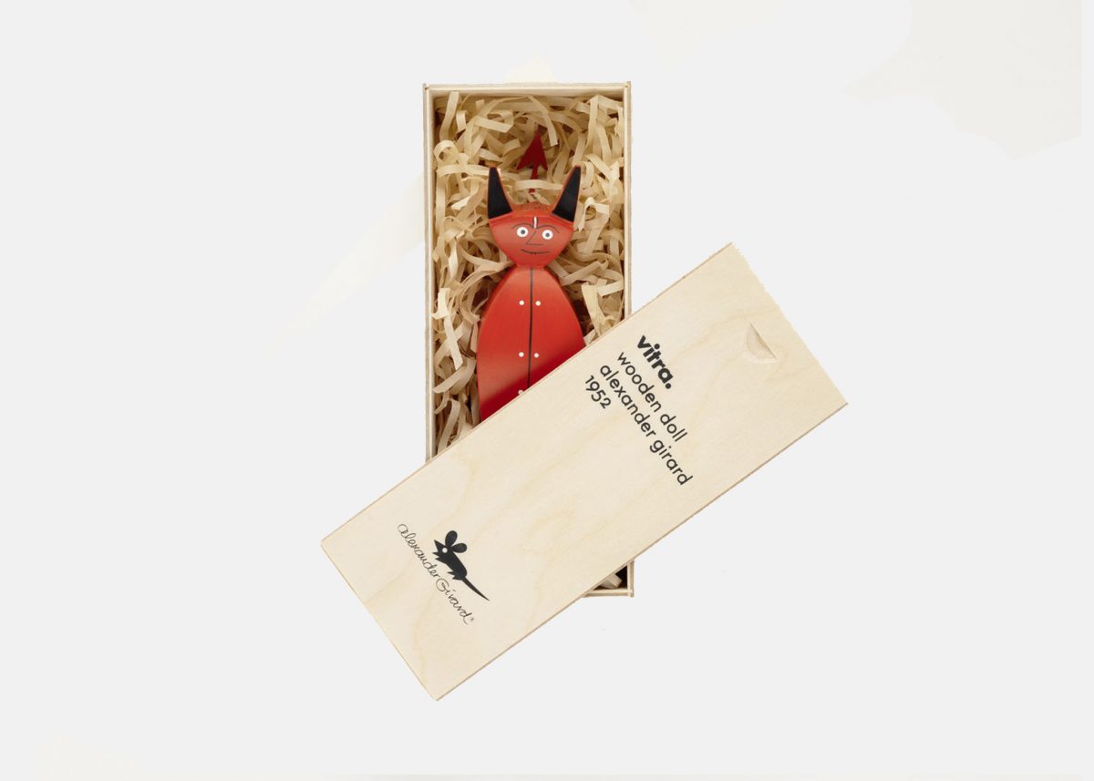 an image of a red devil figurine inside a casket