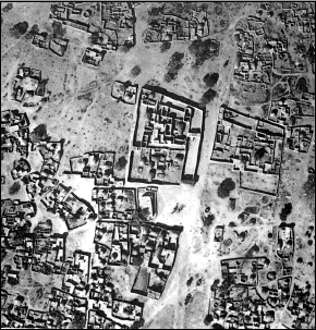 An aerial view of a village in black and white.
