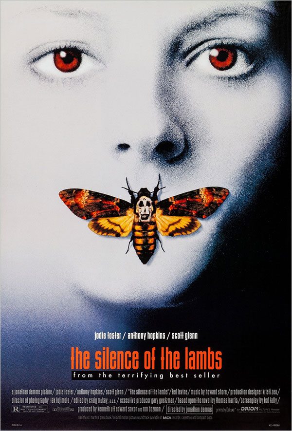 photographic poster of a woman's face in greyscale with bright brown eyes and a moth covering her mouth