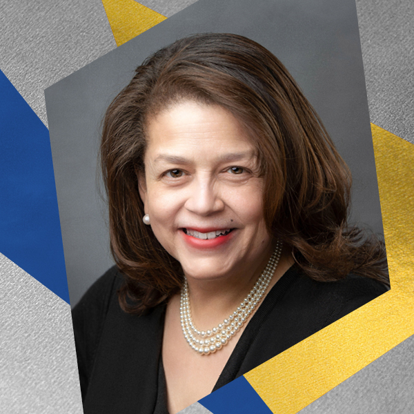 A headshot of a woman smiling wearing white pearl earrings and necklace inlaid on a gray, gold, and blue geometric textured graphic.