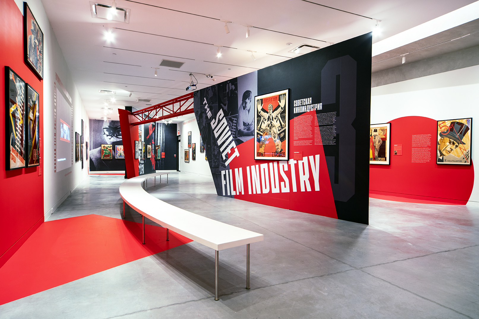 A bench swinging through two freestanding walls and connected by a red industrial beam in a soviet poster show.