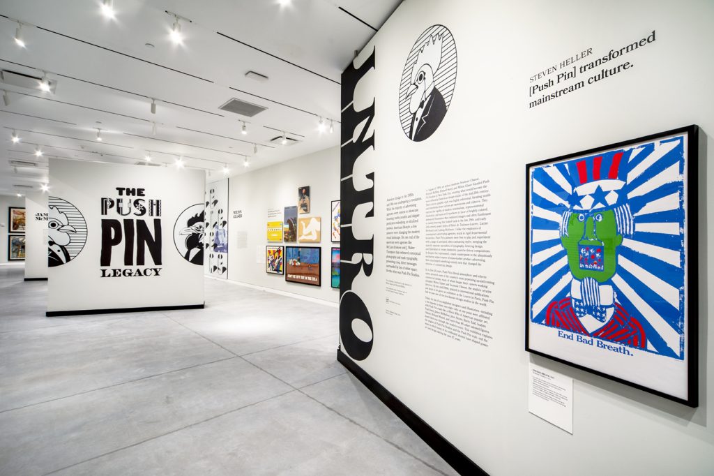 A view of the open push pin gallery with white walls and colorful posters.