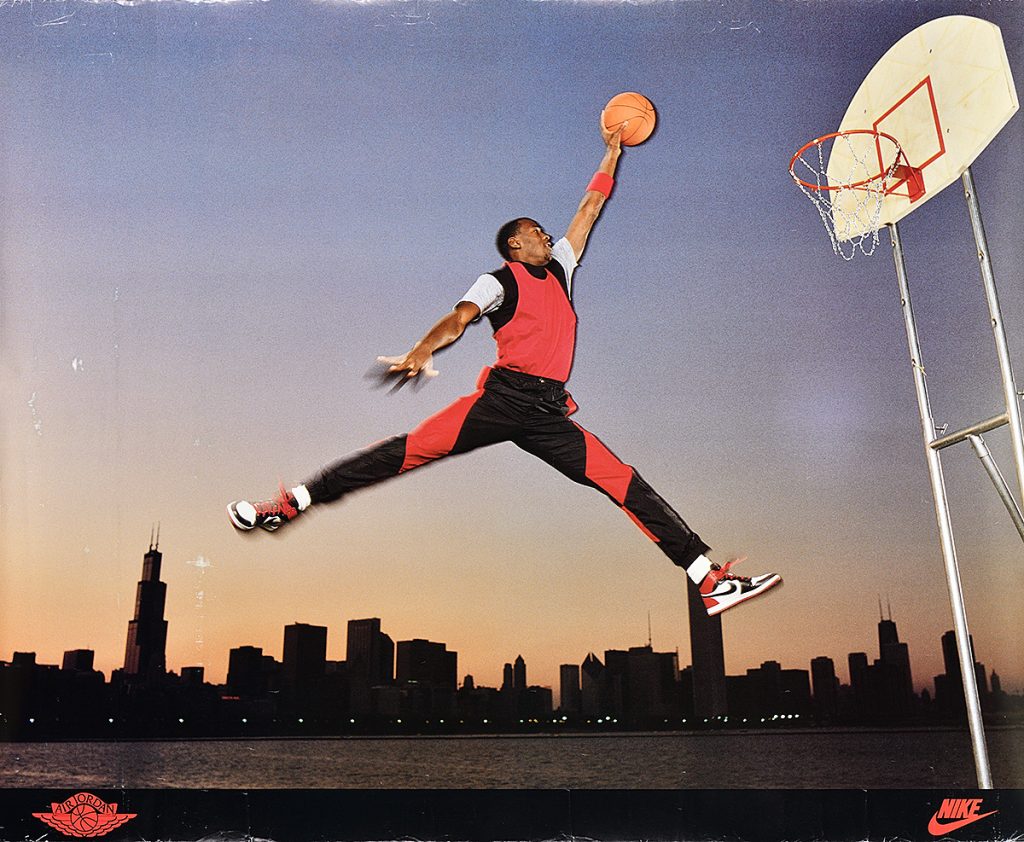 Poster of a man flying through the air about to dunk a basketball.