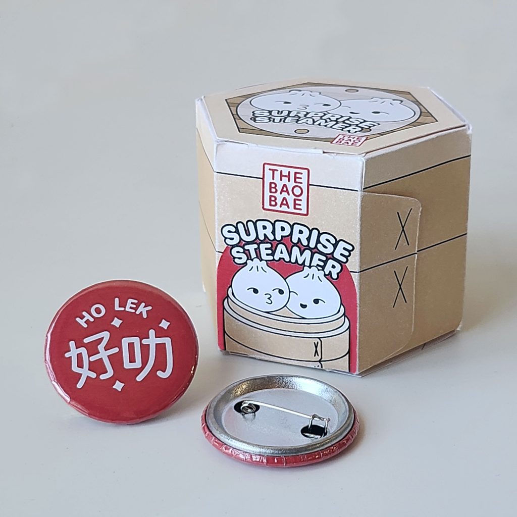 A photograph of a blind box and a button