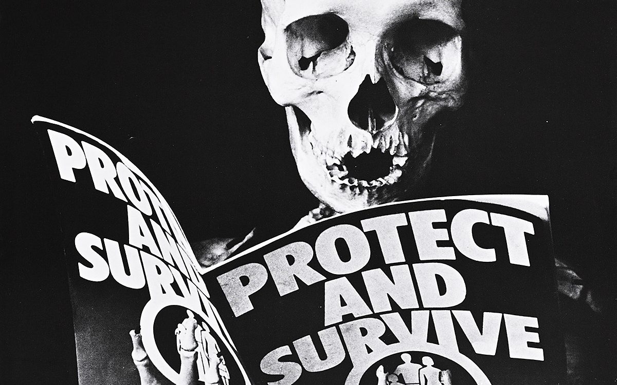 Poster of a skeleton reading a civil defense magazine.