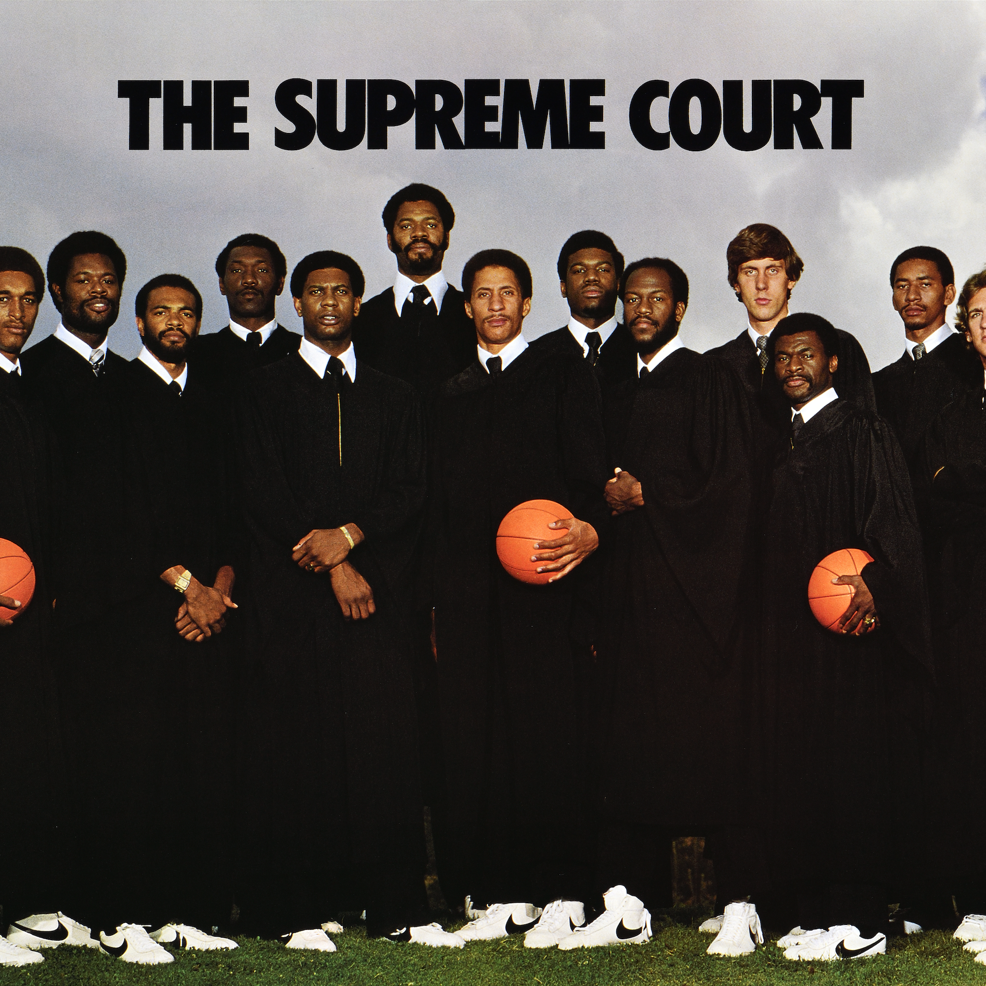 A basketball team is dressed in judges' robes