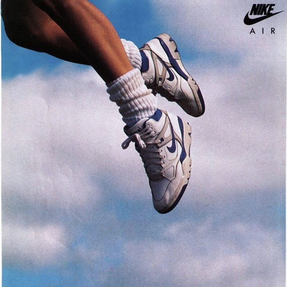 A poster image of a woman in Nike shoes flying in the air