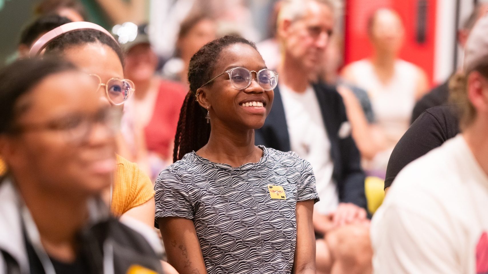 A photo of a student smiling at an event at Poster House.