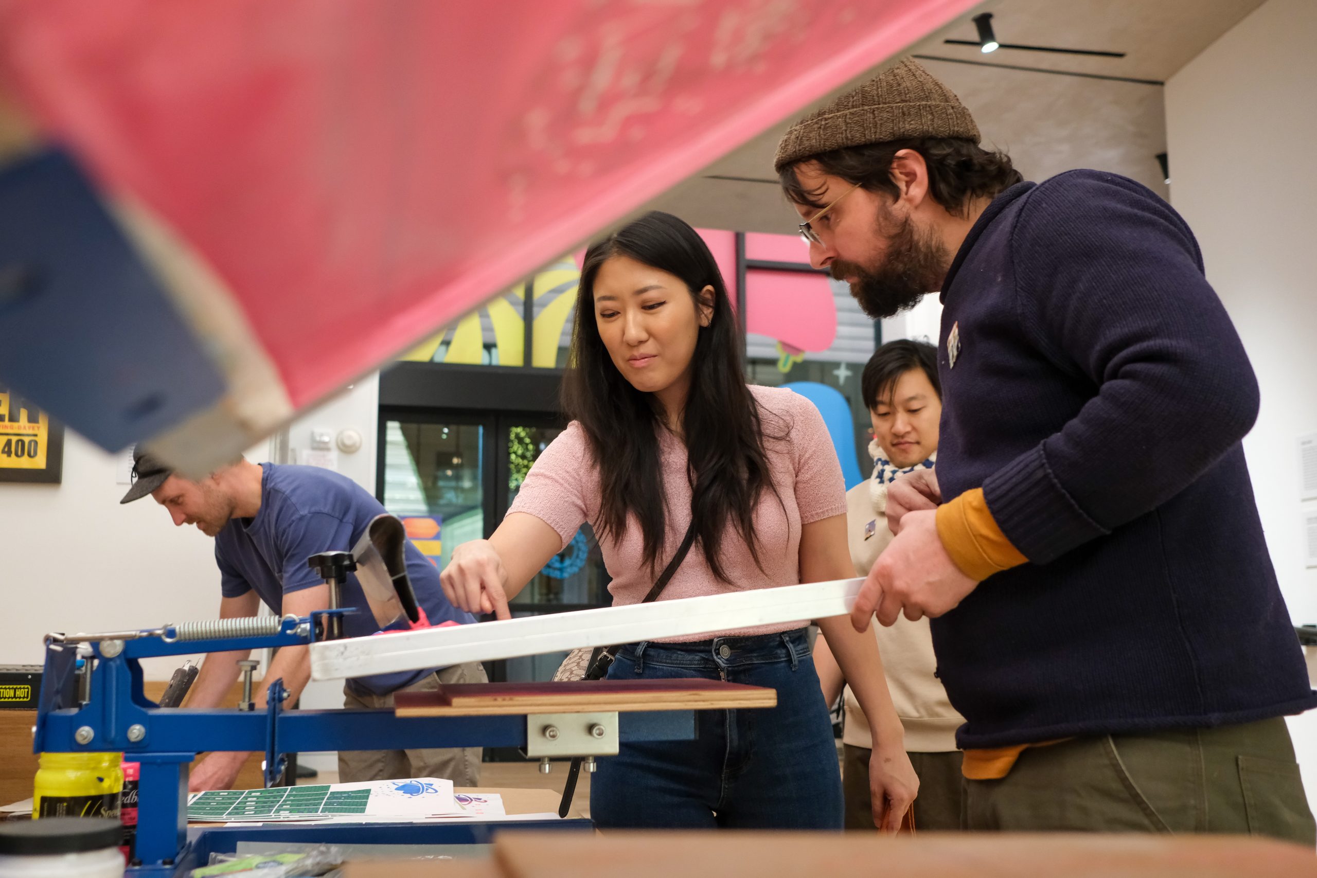 A member engaging in screen printing event at Poster House.