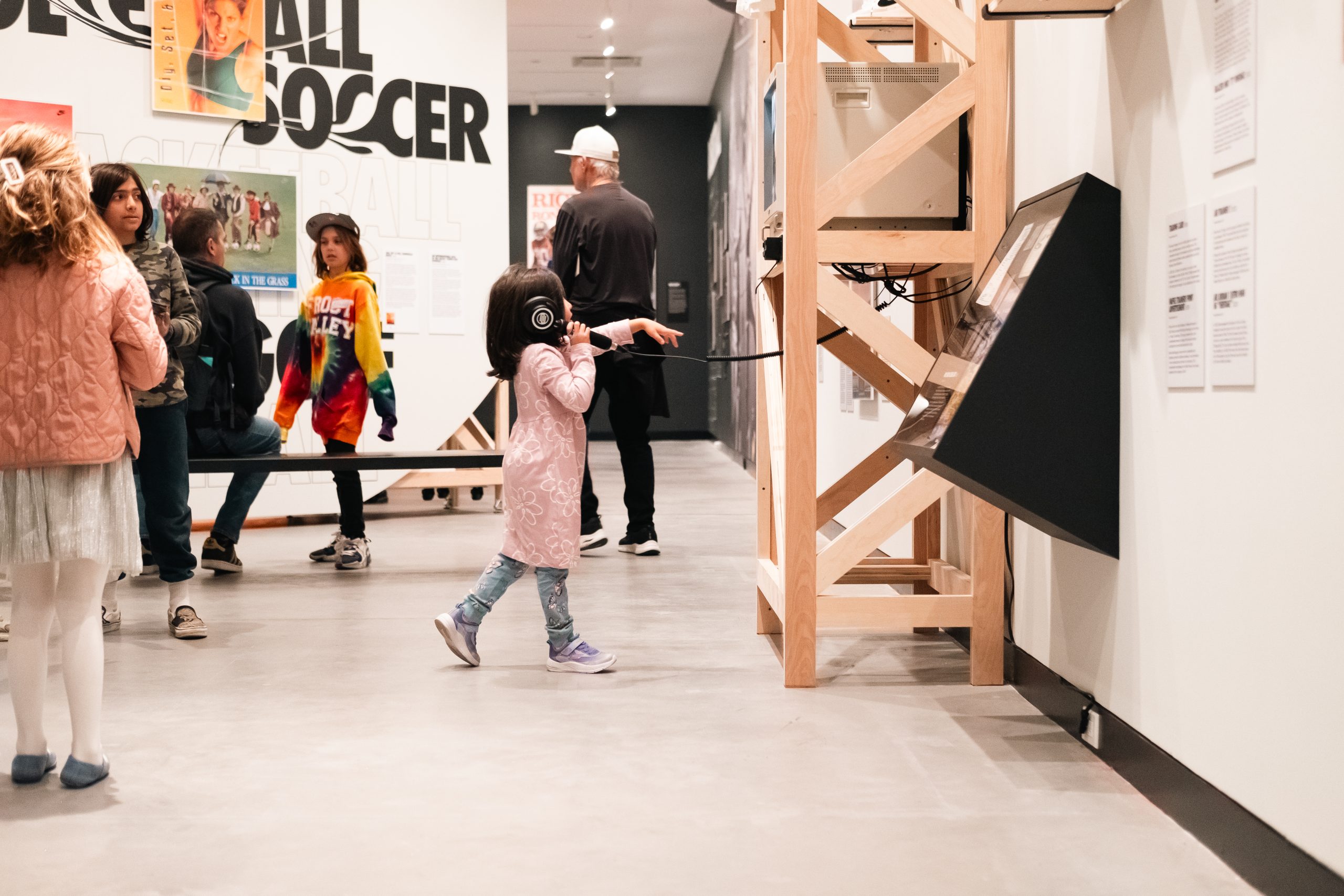 A child interacting with an exhibition at Poster House.