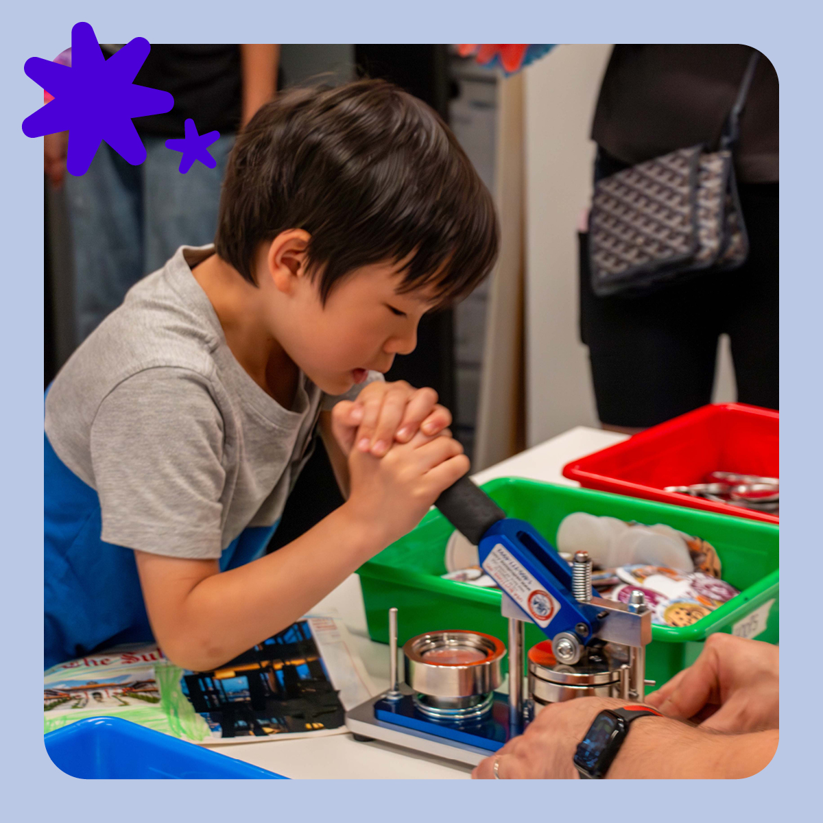 Digital image of a child using a button maker