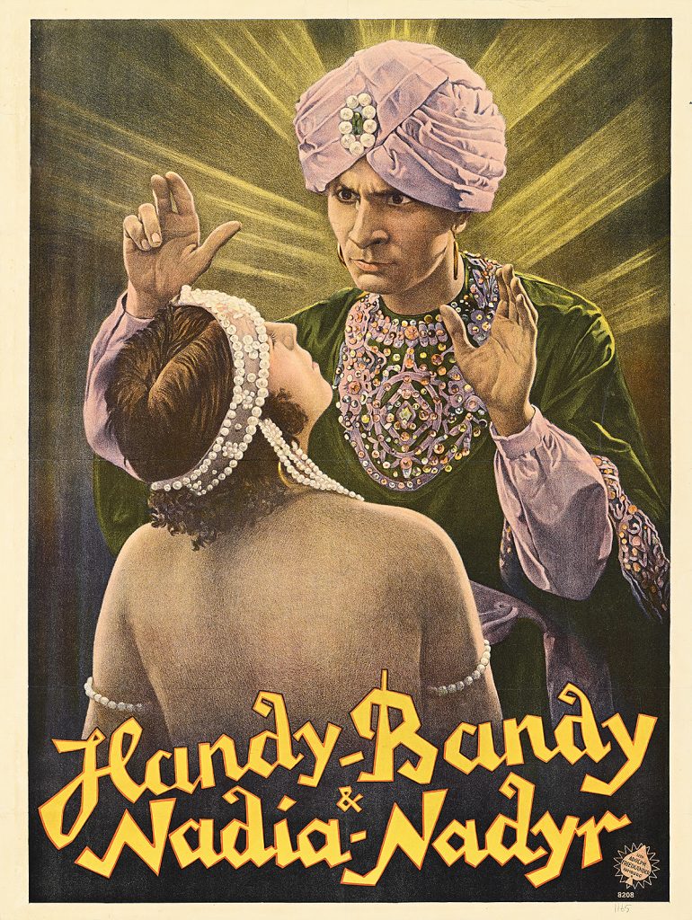 Poster of a man wearing a turban hypnotizing a woman.