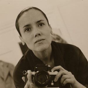 a young woman holding a film camera