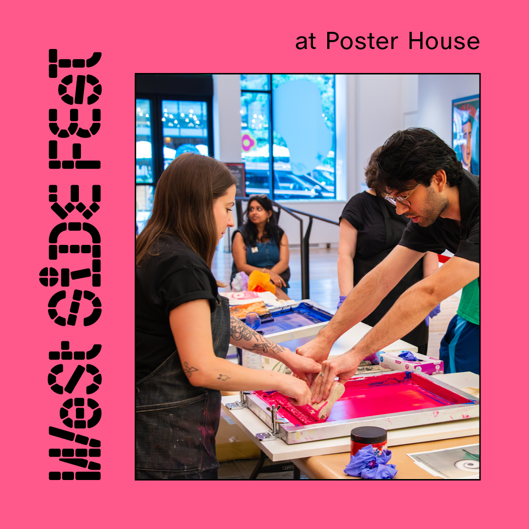 Two people leaning over a table making a screenprint.