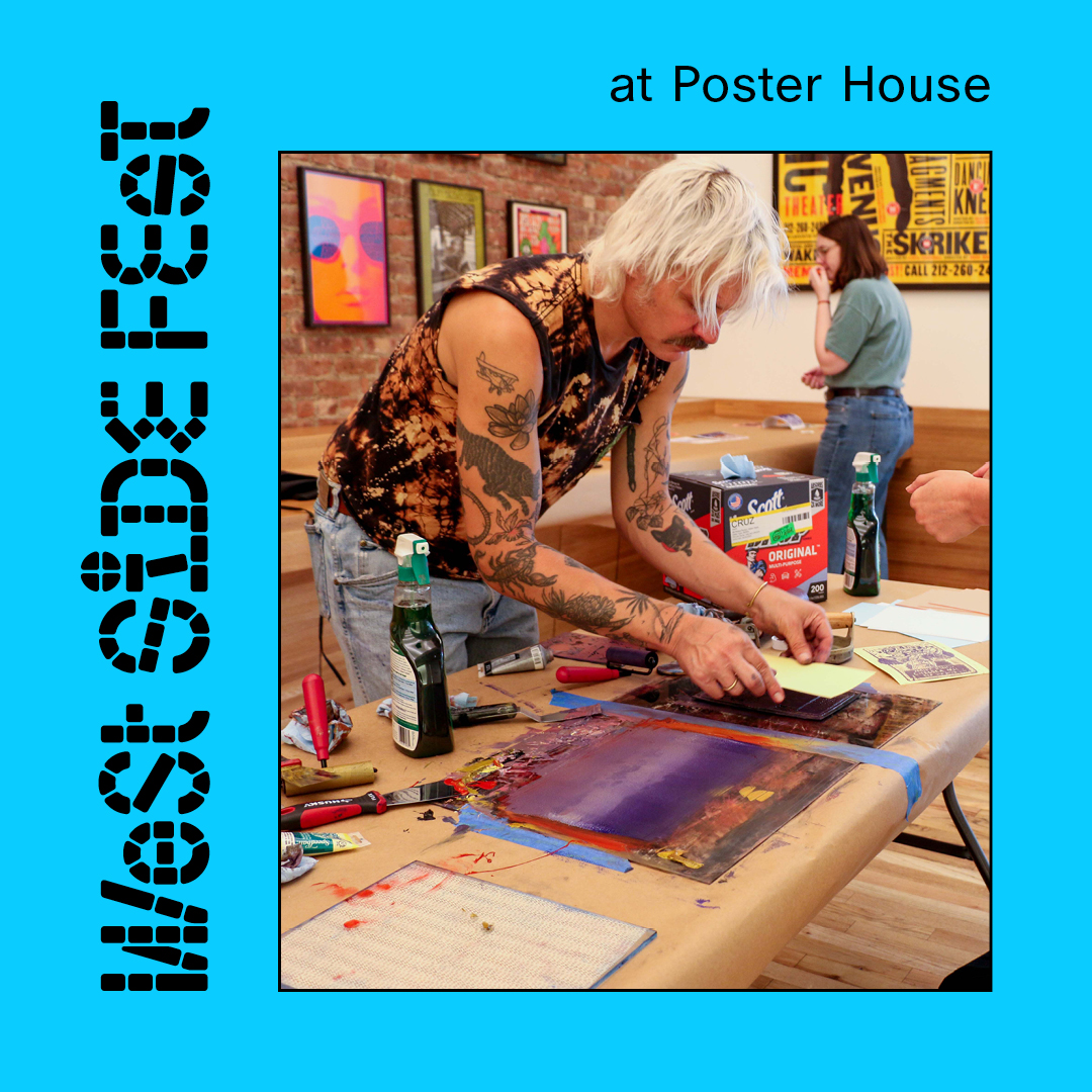 A person leaning over a table making a block print.