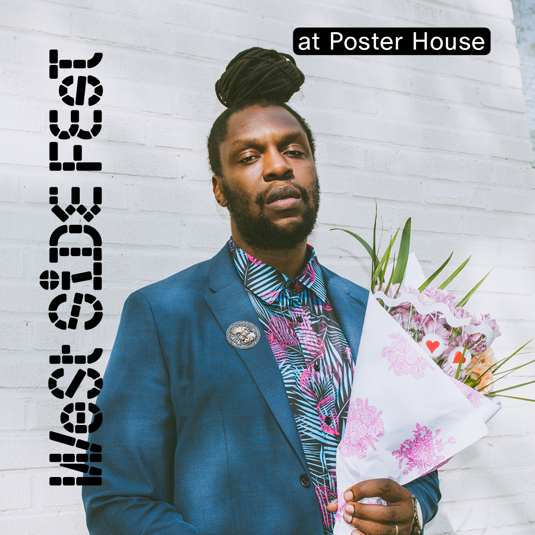 A man in a blue suit holding a bouquet of flowers