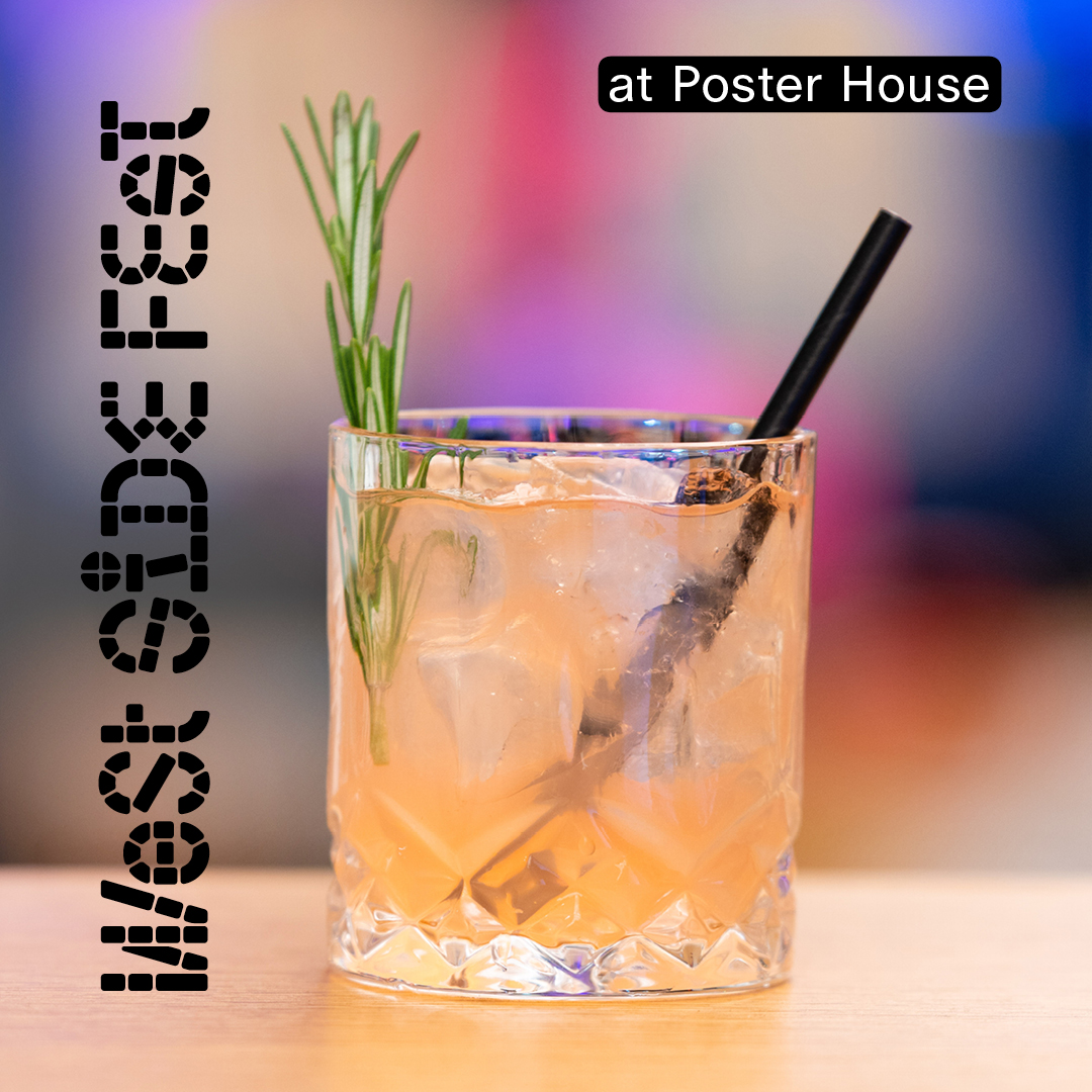 A peach colored cocktail in a rocks glass with a black straw and a rosemary sprig sticking out of it