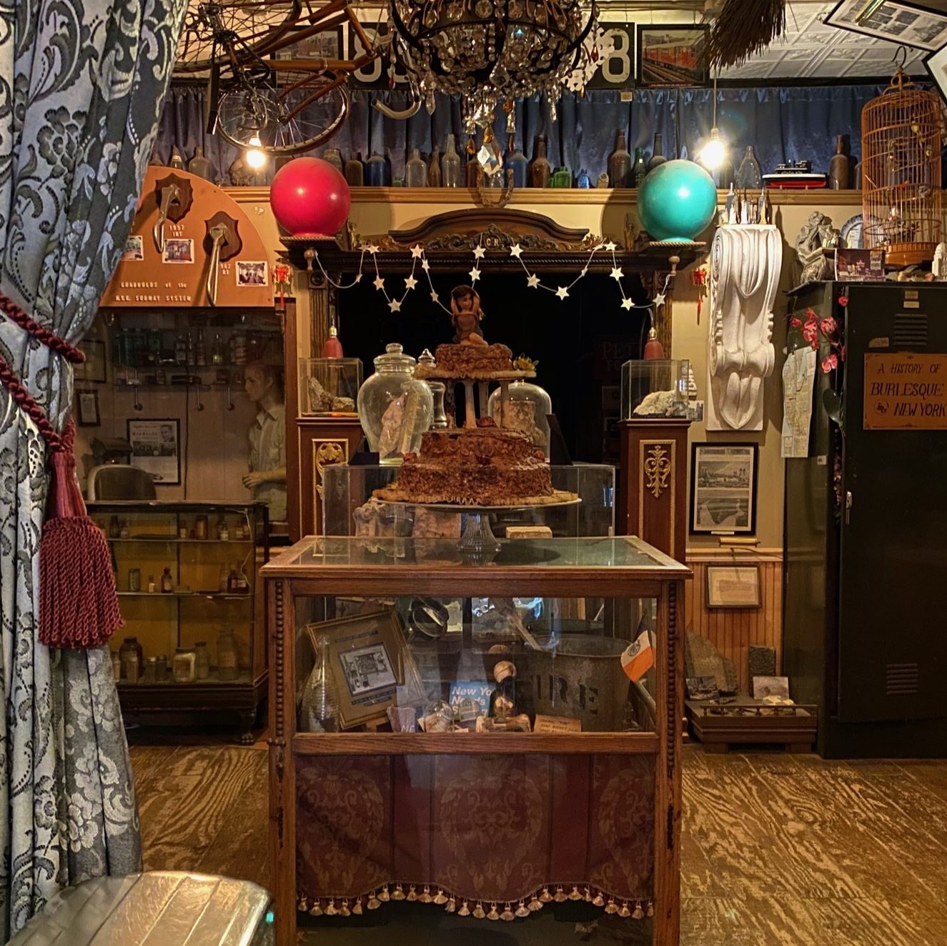 A room crowded with antique knickknacks and curio cabinets.