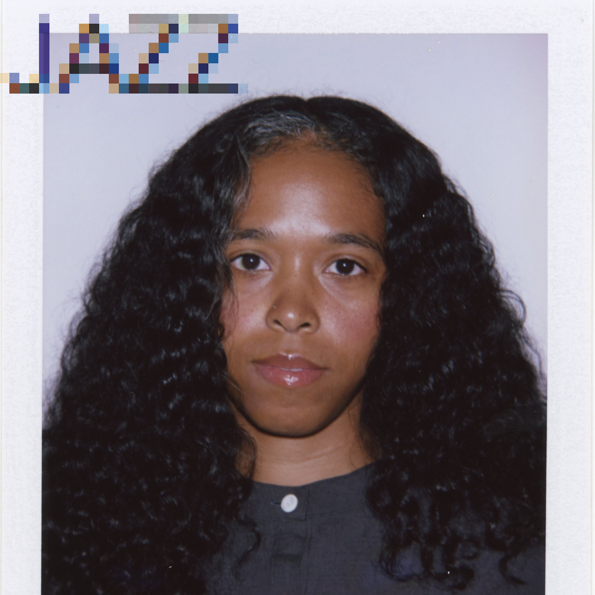Portrait photograph of a person with long curly dark hair.