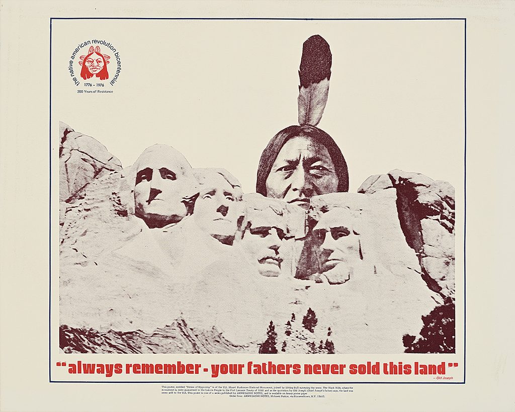 An Indigenous man's head above Mount Rushmore with red text reading: always remember - your fathers never sold this land