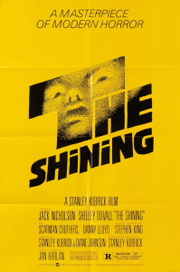 A yellow poster for The Shining. There is a horrified face reflected in the T of "The."